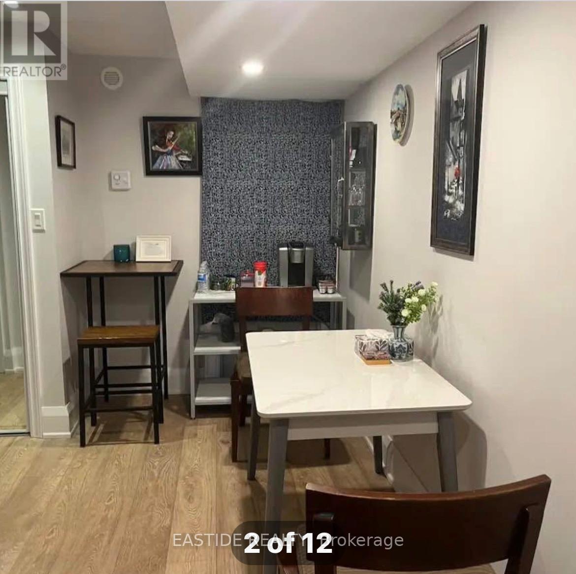 A dining room with a table and chairs.