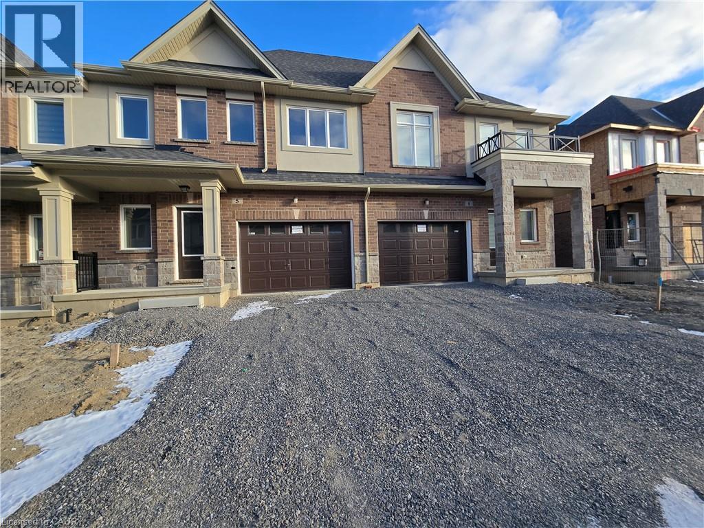 A large, multi-level house with a garage is shown in the image.