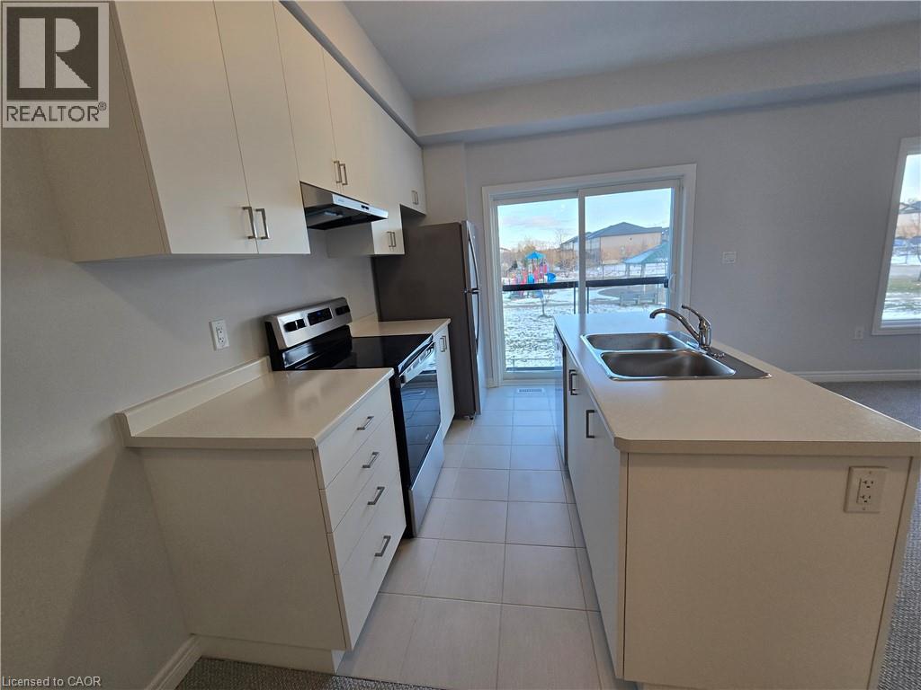 A kitchen with white cabinets and a black oven.