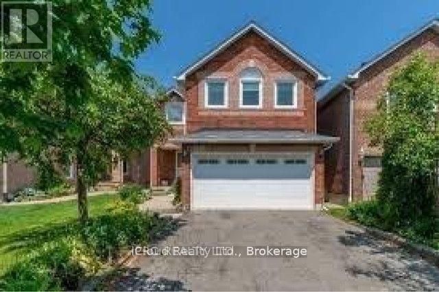 A house with a brown brick exterior and a white garage door is for sale.