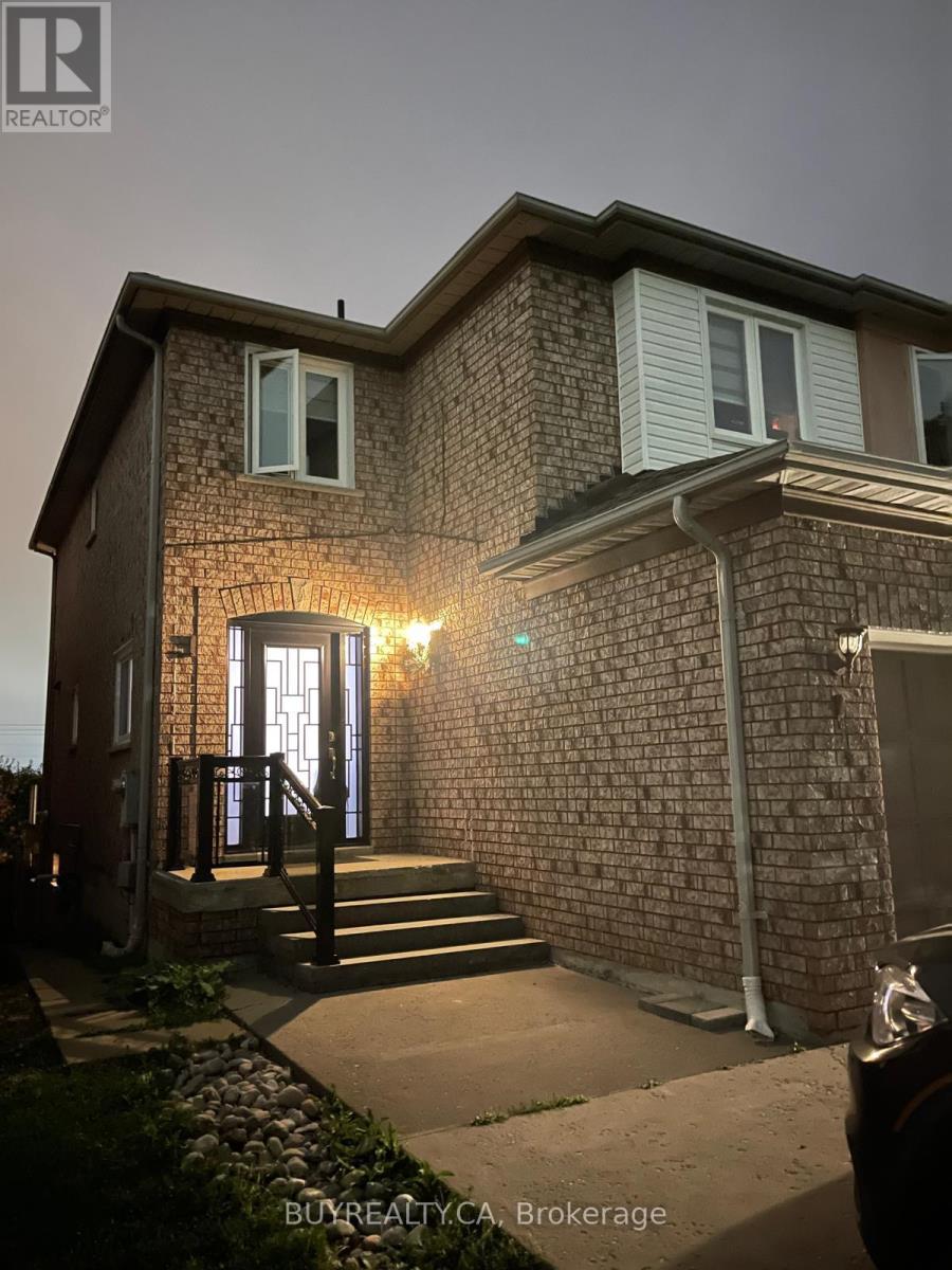A house with a brick facade and a lit up entrance.