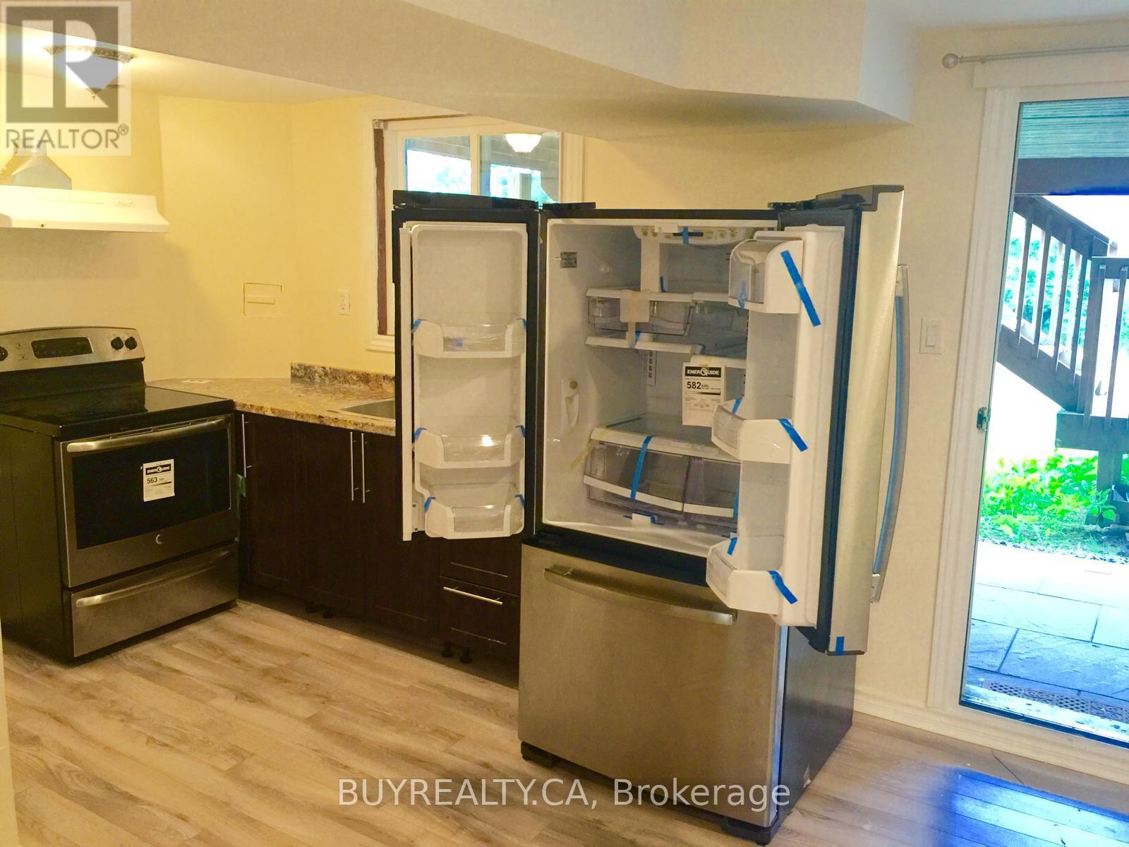 A refrigerator with its door open in a kitchen.