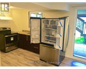 A refrigerator with its door open in a kitchen.