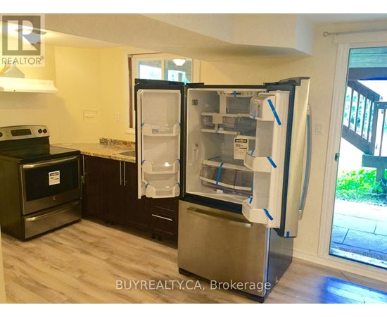 A refrigerator with its door open in a kitchen.