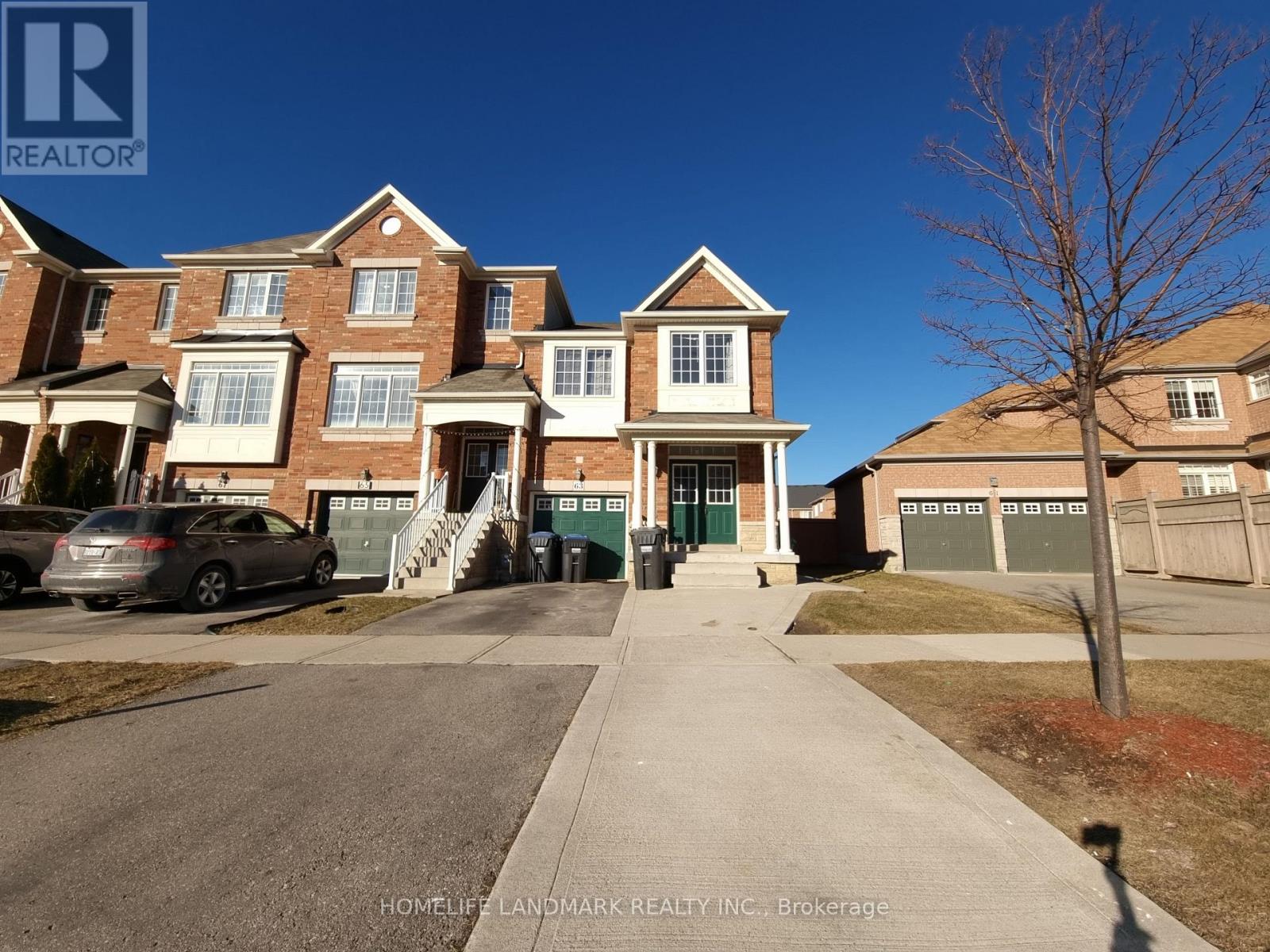 A large brick house with a tree in front of it.