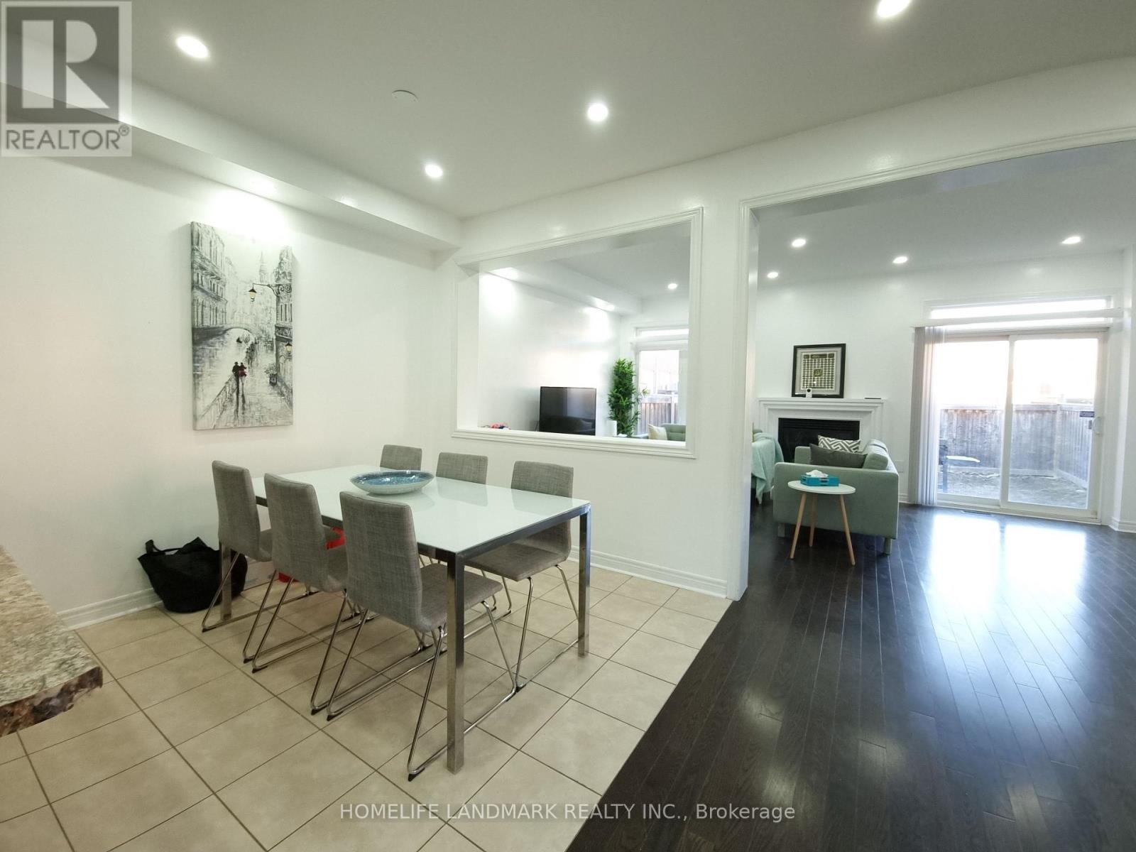 A dining room with a table and chairs.