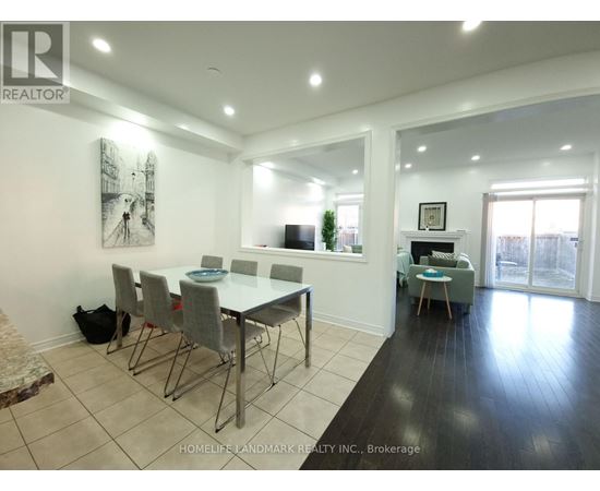 A dining room with a table and chairs.