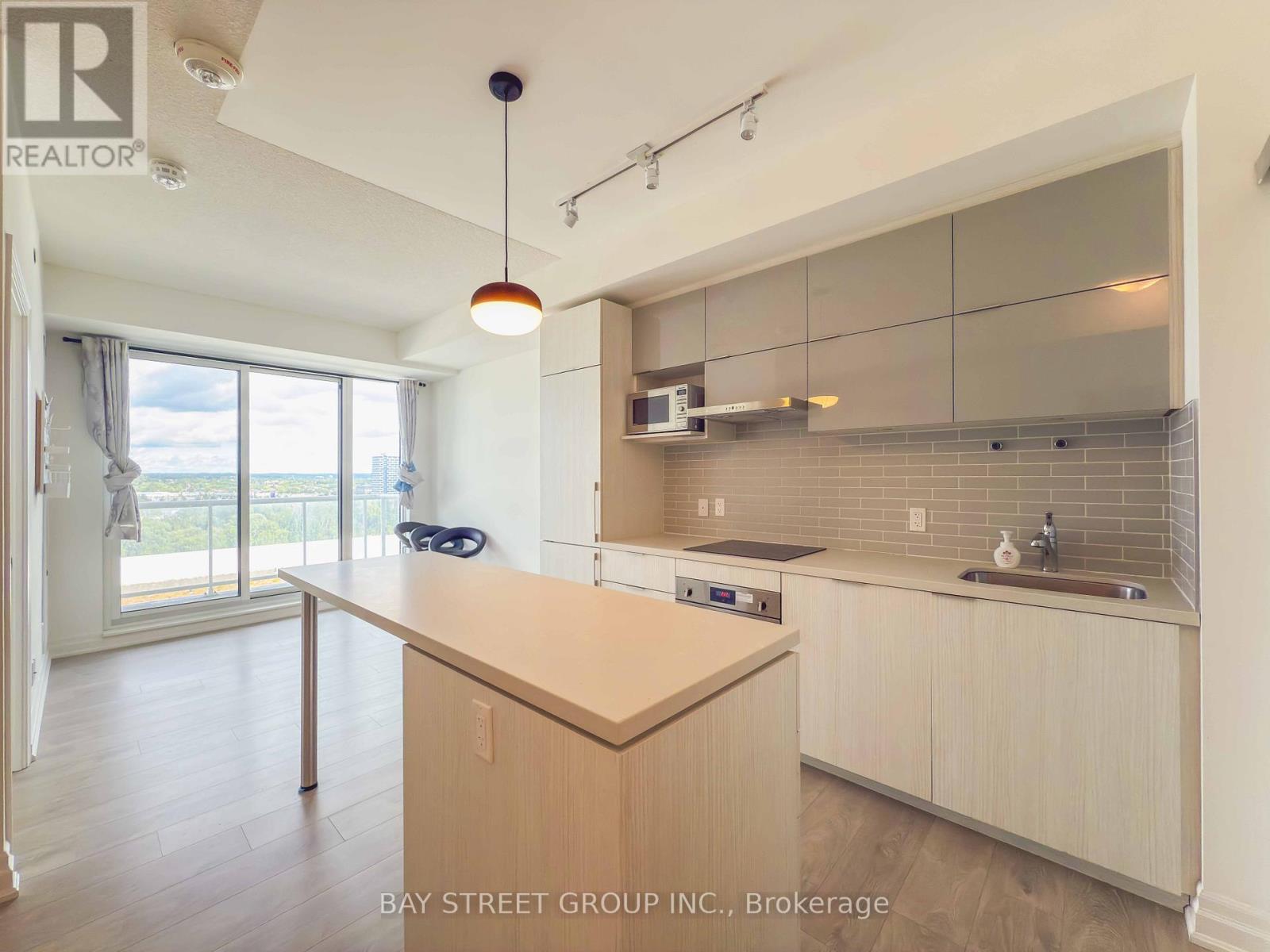 A kitchen with a wooden counter top and a sink.