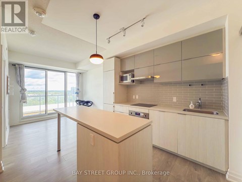A kitchen with a wooden counter top and a sink.