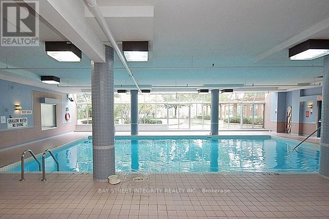 A large indoor swimming pool with a sign that says "REALTOR".