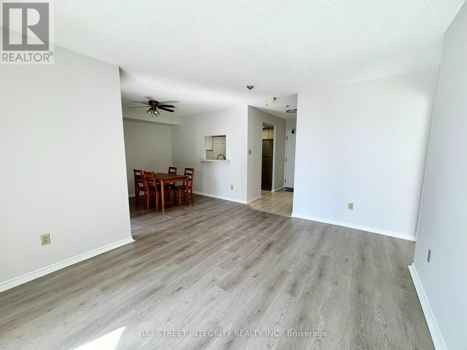 A spacious room with a dining table and chairs is on the market.