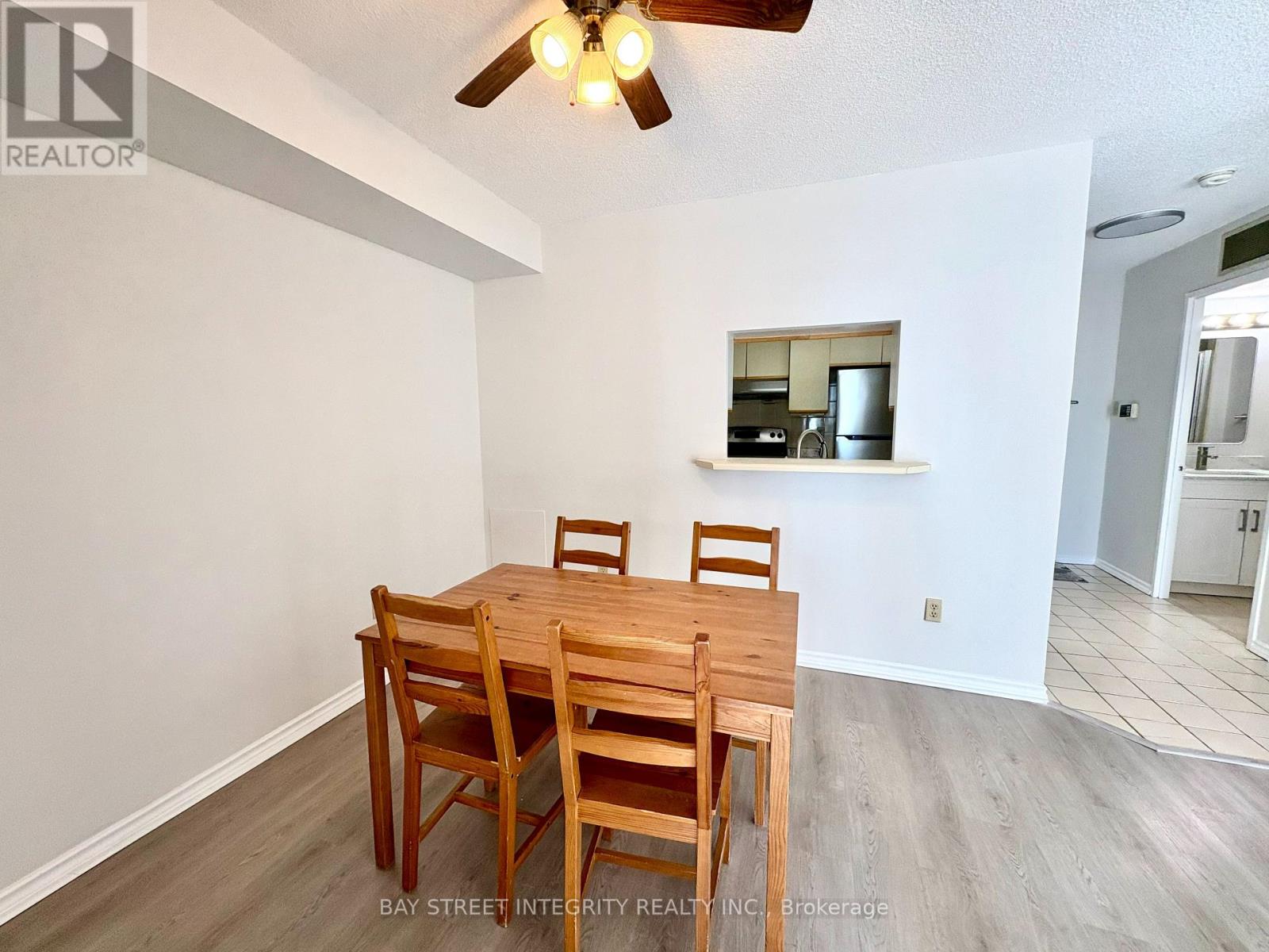 A dining room with a wooden table and chairs.