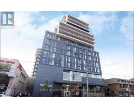 A modern multi-story building with a glass facade is the focal point of the image.