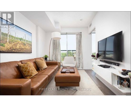 A living room with a brown leather couch and a television on the wall.