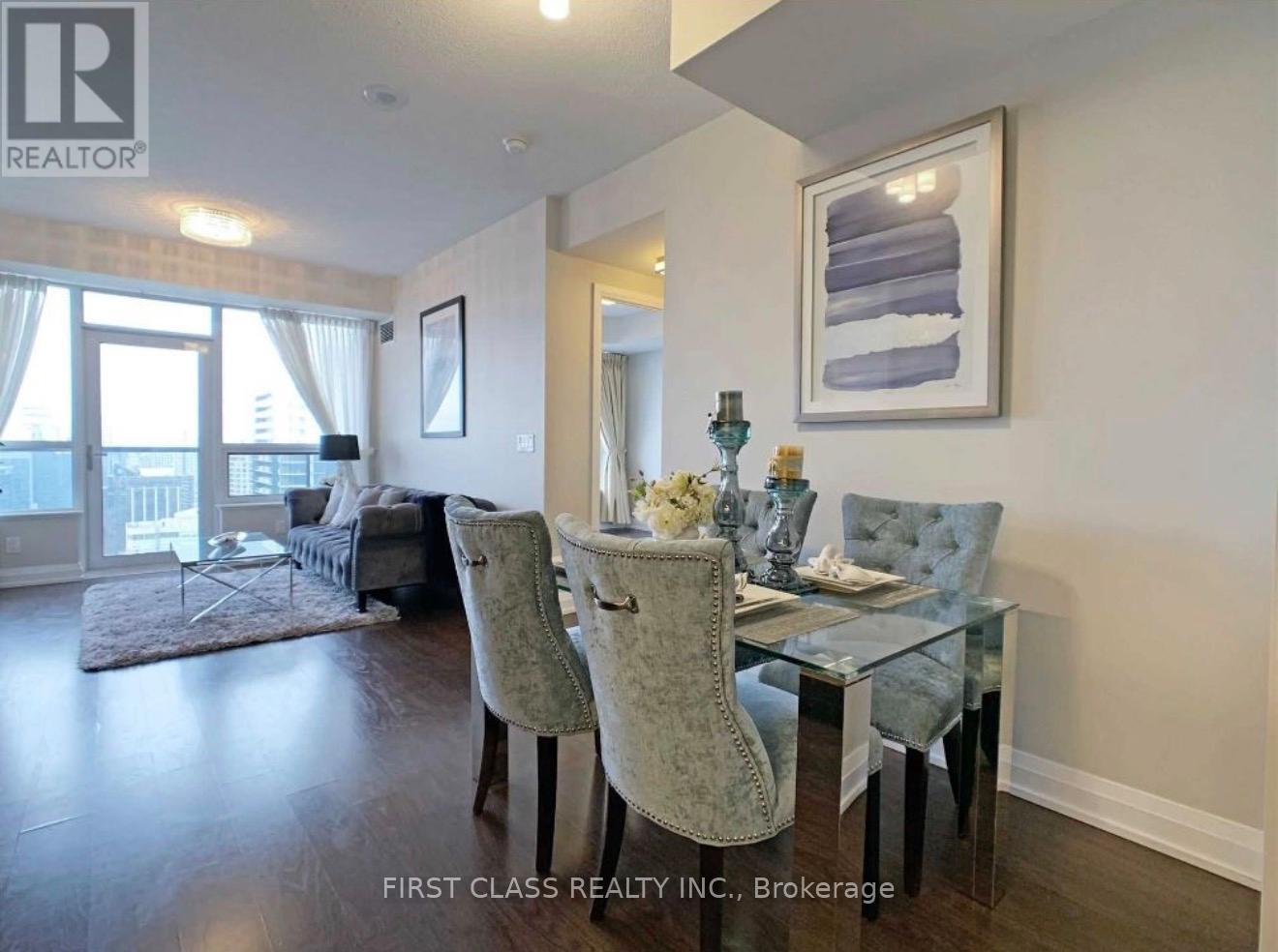 A dining room with a glass table and chairs.