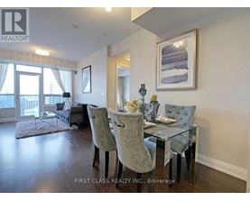 A dining room with a glass table and chairs.