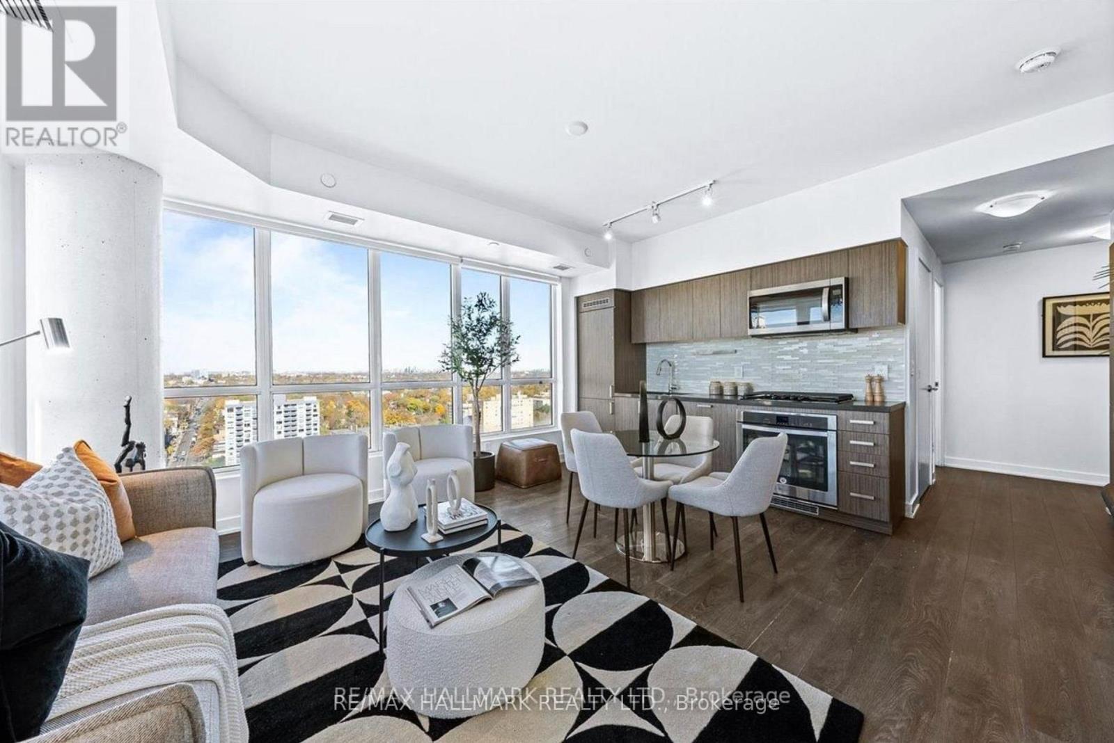 A modern living room with a large window overlooking the city.