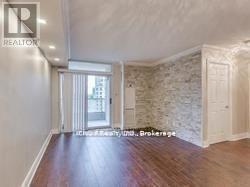 A room with wooden floors and a stone wall.