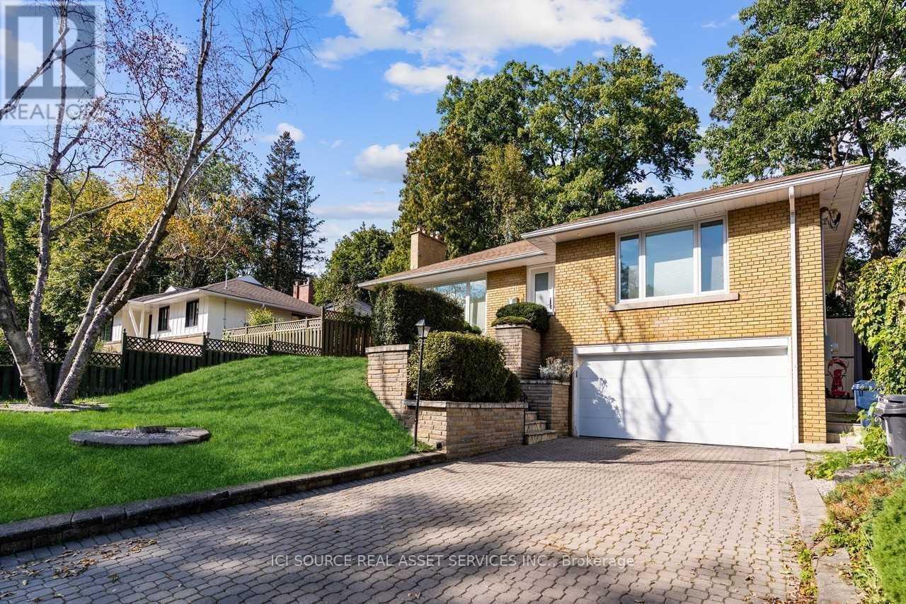 A house with a white garage door and a brick driveway.