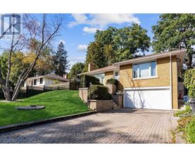A house with a white garage door and a brick driveway.
