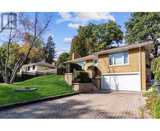 A house with a white garage door and a brick driveway.