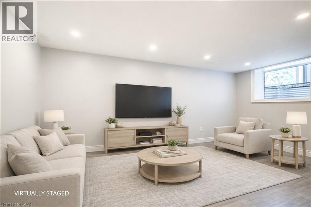 A living room with a grey couch, a coffee table, a television, and a lamp.