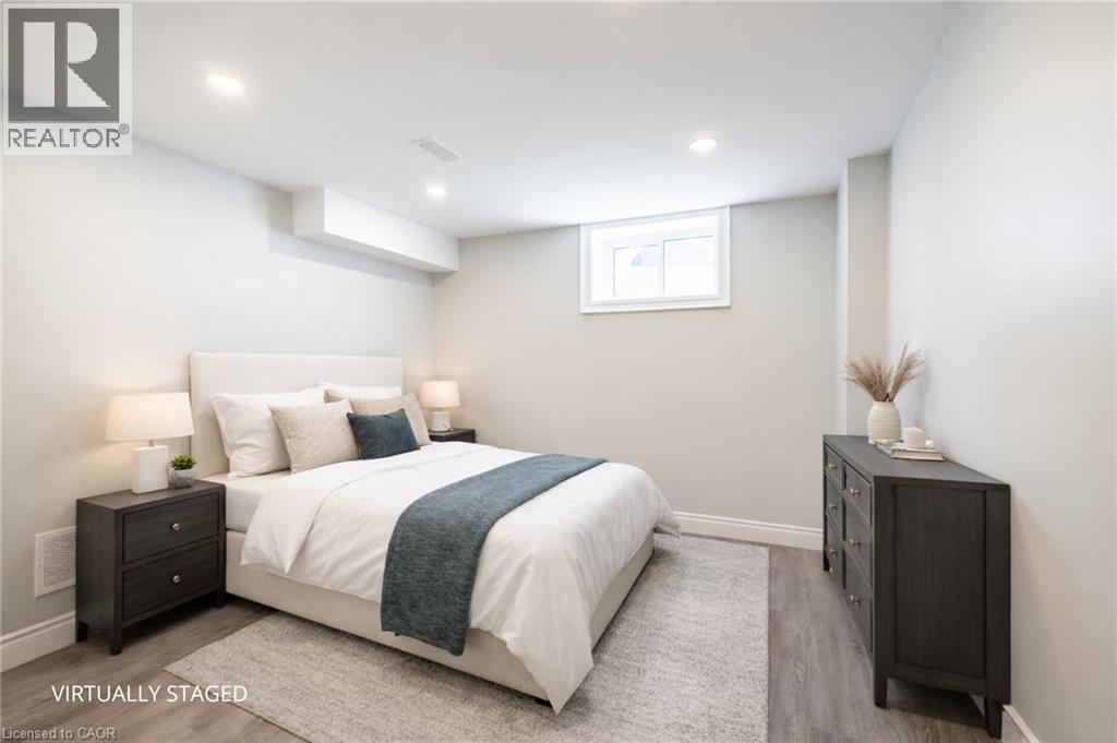 A bedroom with a bed, nightstands, and a dresser.
