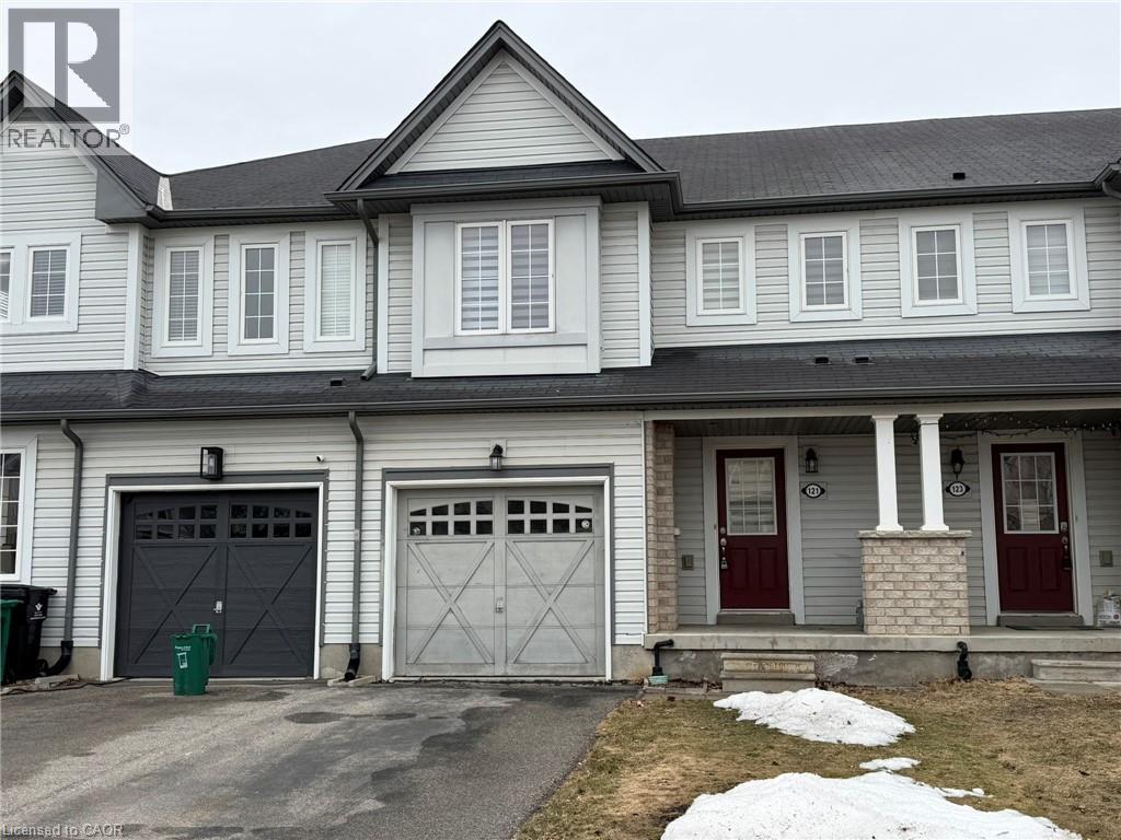 A two-story house with a grey exterior and red doors.