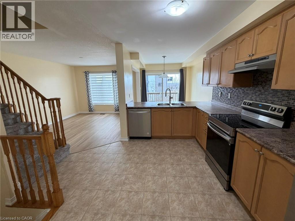 A kitchen with wooden cabinets and a tiled floor.