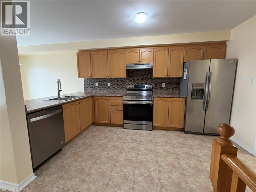 A kitchen with wooden cabinets and stainless steel appliances.