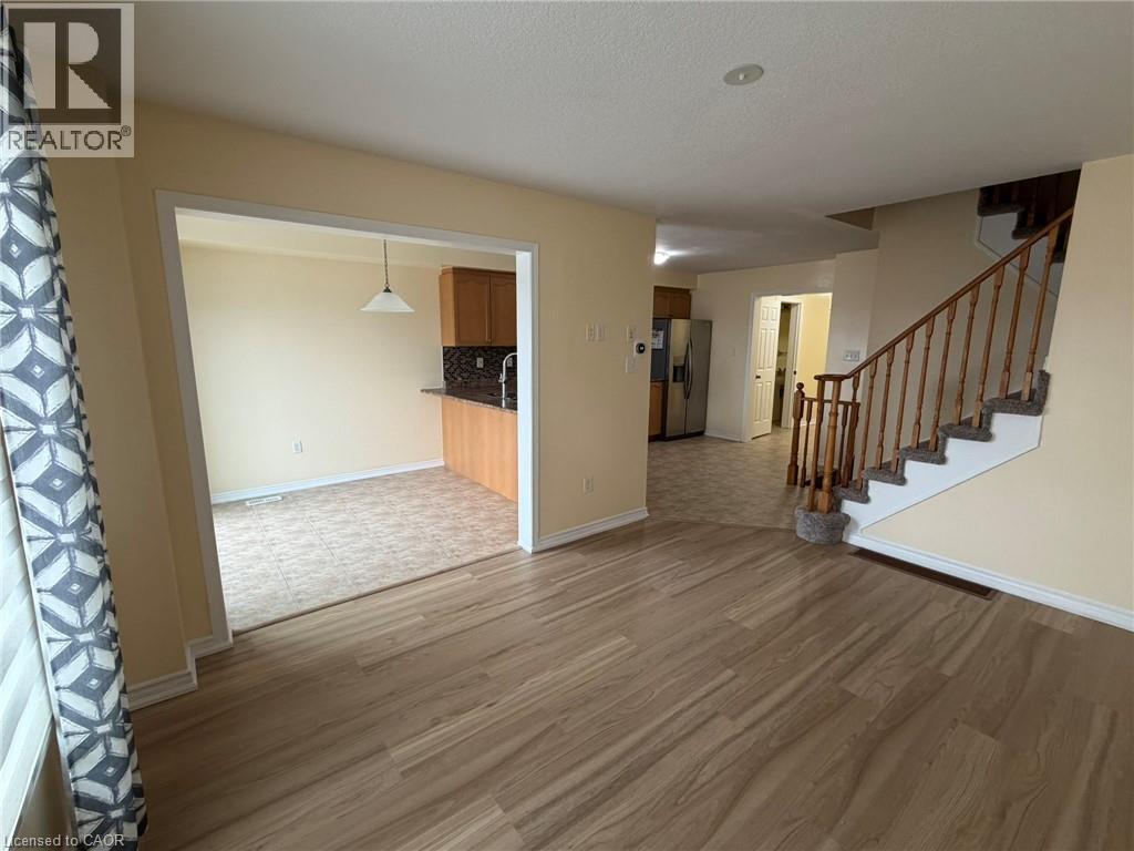 A living room with a staircase leading to the upper floor.