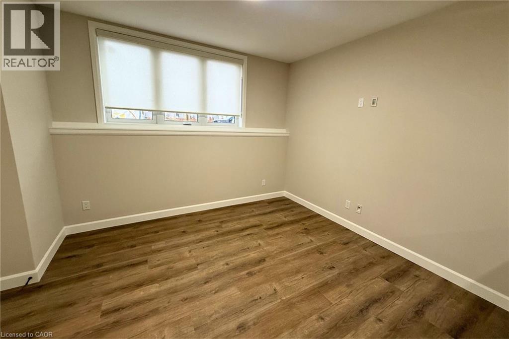 A room with wooden flooring and a window.