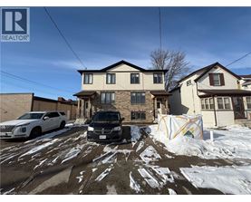 A house with a car parked in front of it.