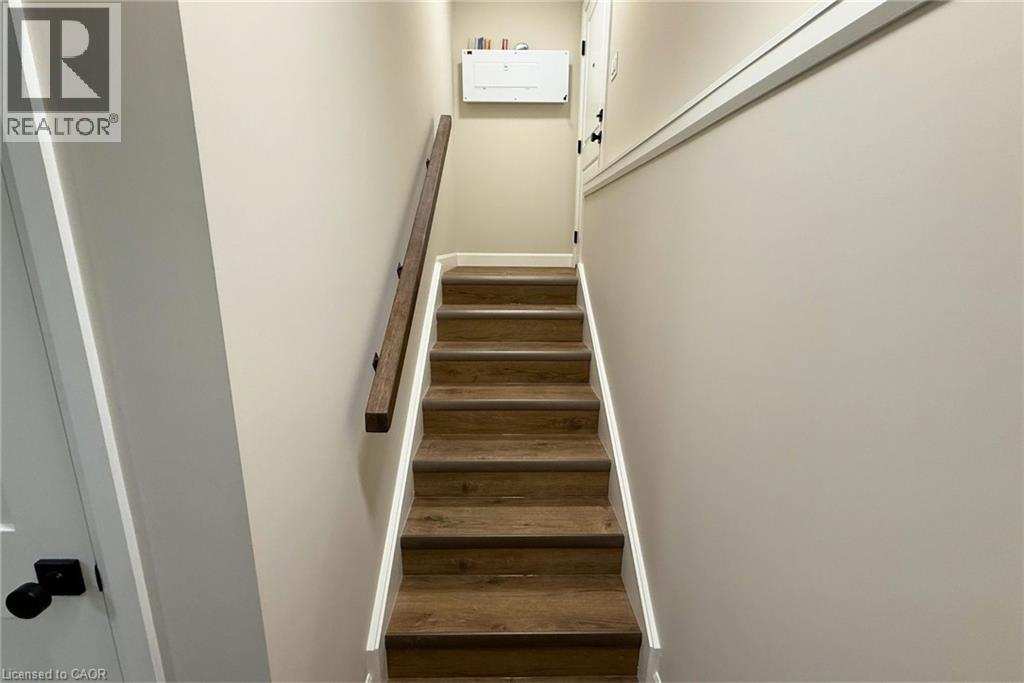 A staircase with wooden steps and white walls.