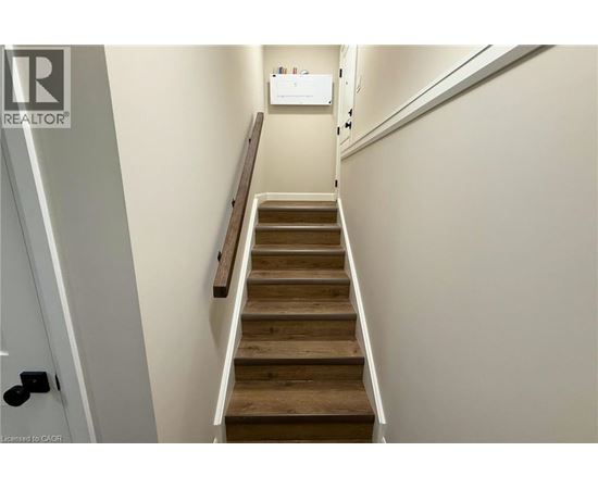 A staircase with wooden steps and white walls.