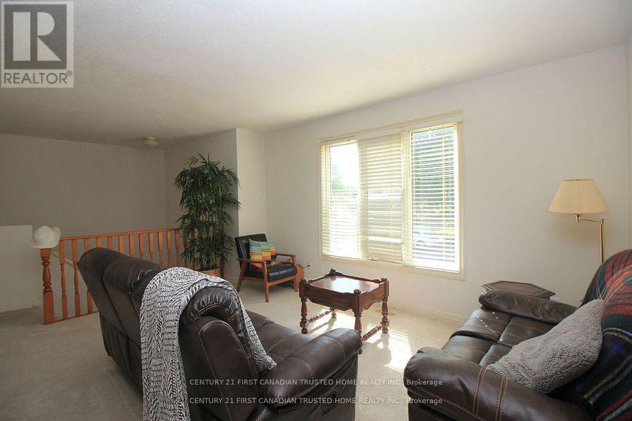 A living room with a brown leather couch and a wooden coffee table.