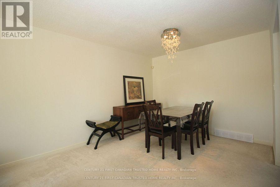 A dining room with a wooden table and chairs.