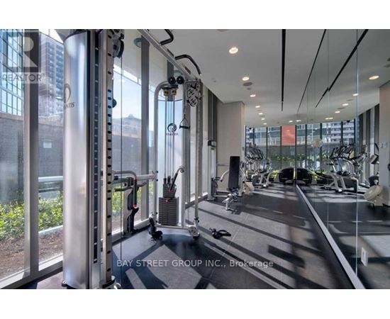 A gym with a view of the city outside the windows.