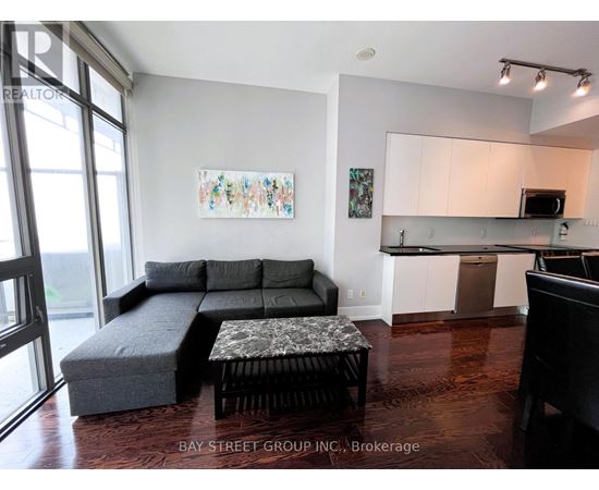A living room with a grey couch and a coffee table.