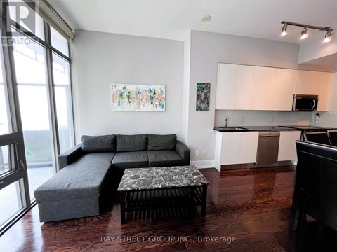 A living room with a grey couch and a coffee table.