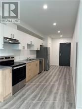 A modern kitchen with wooden cabinets and stainless steel appliances.