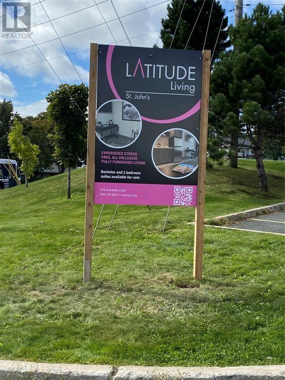 A sign for a living facility called Latitude Living is displayed outdoors.
