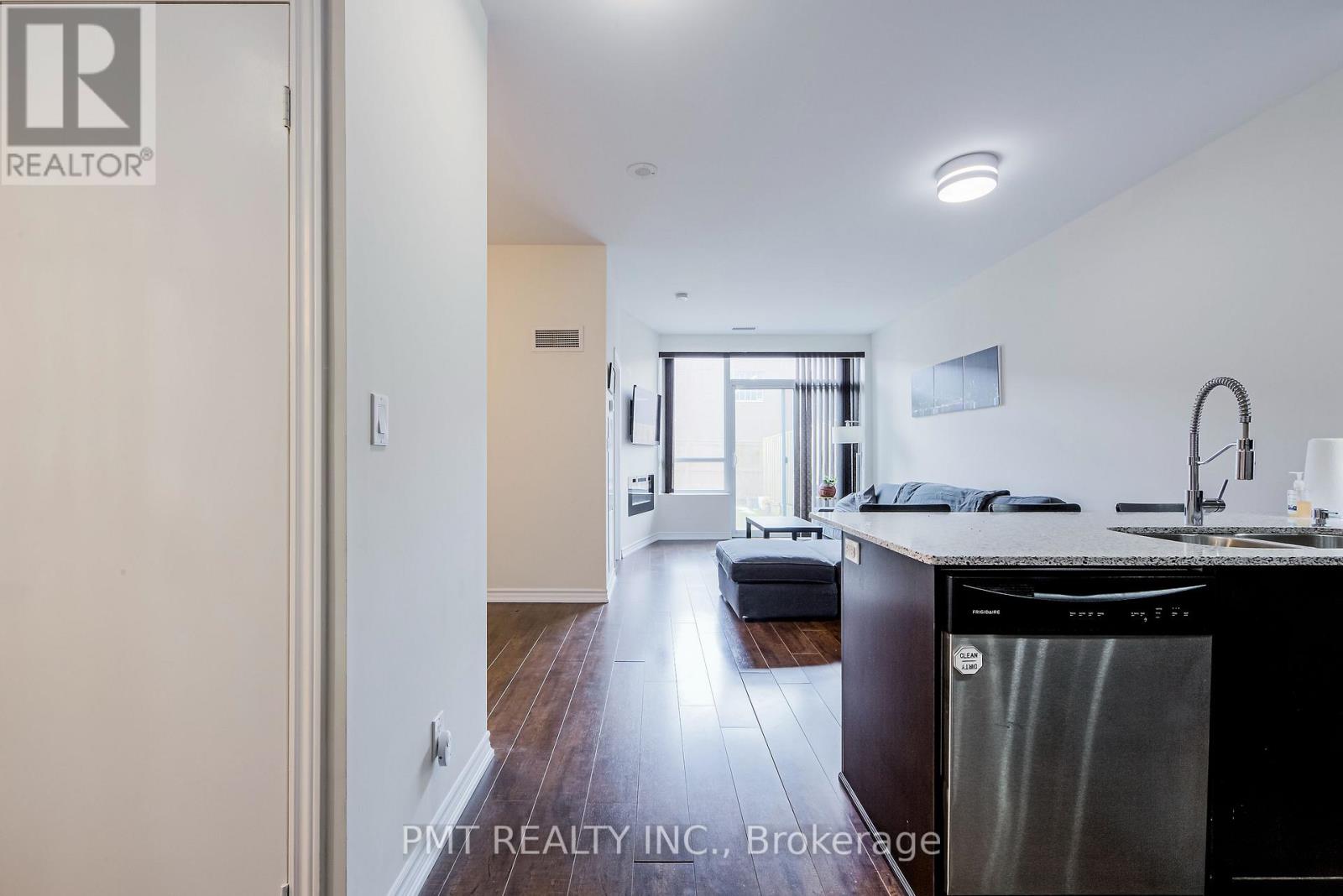 A kitchen with a stainless steel dishwasher and a sink.