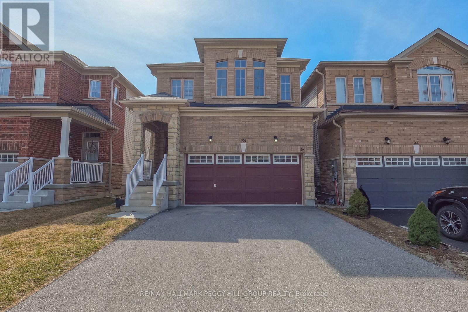 A large, two-story house with a garage is for sale.