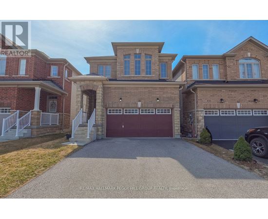 A large, two-story house with a garage is for sale.
