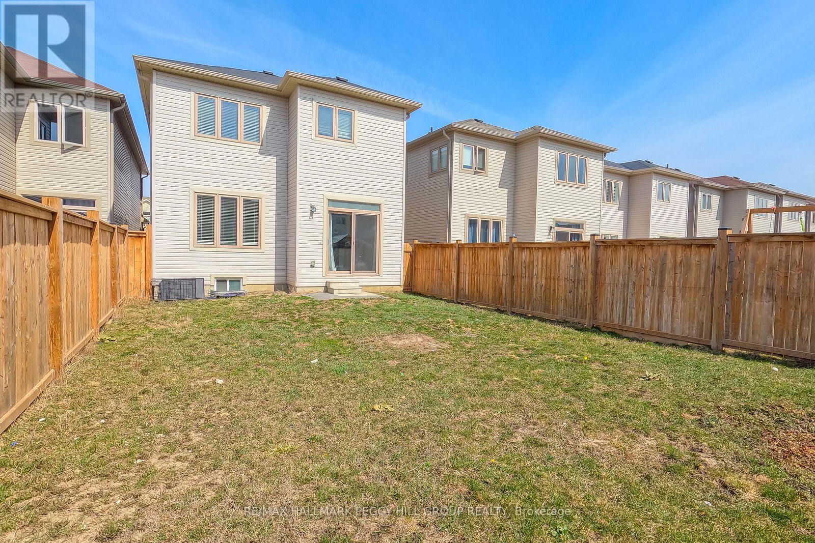 A row of houses with a grassy yard in front.