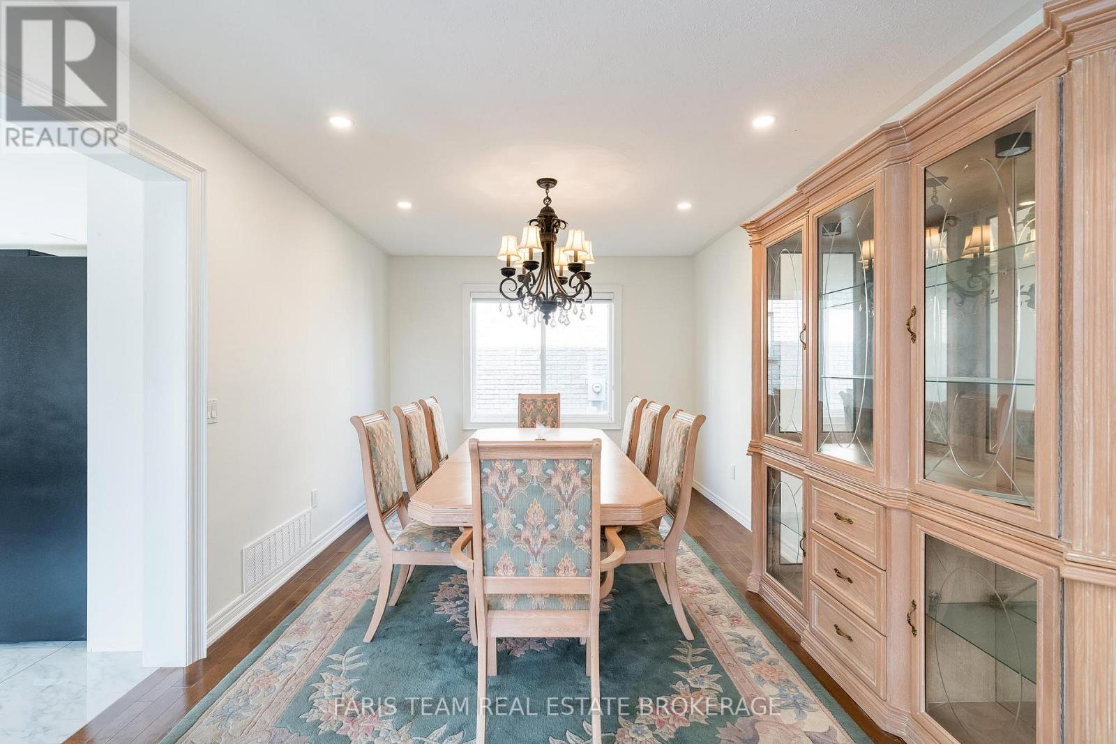 A kitchen with white cabinets and a large island.
