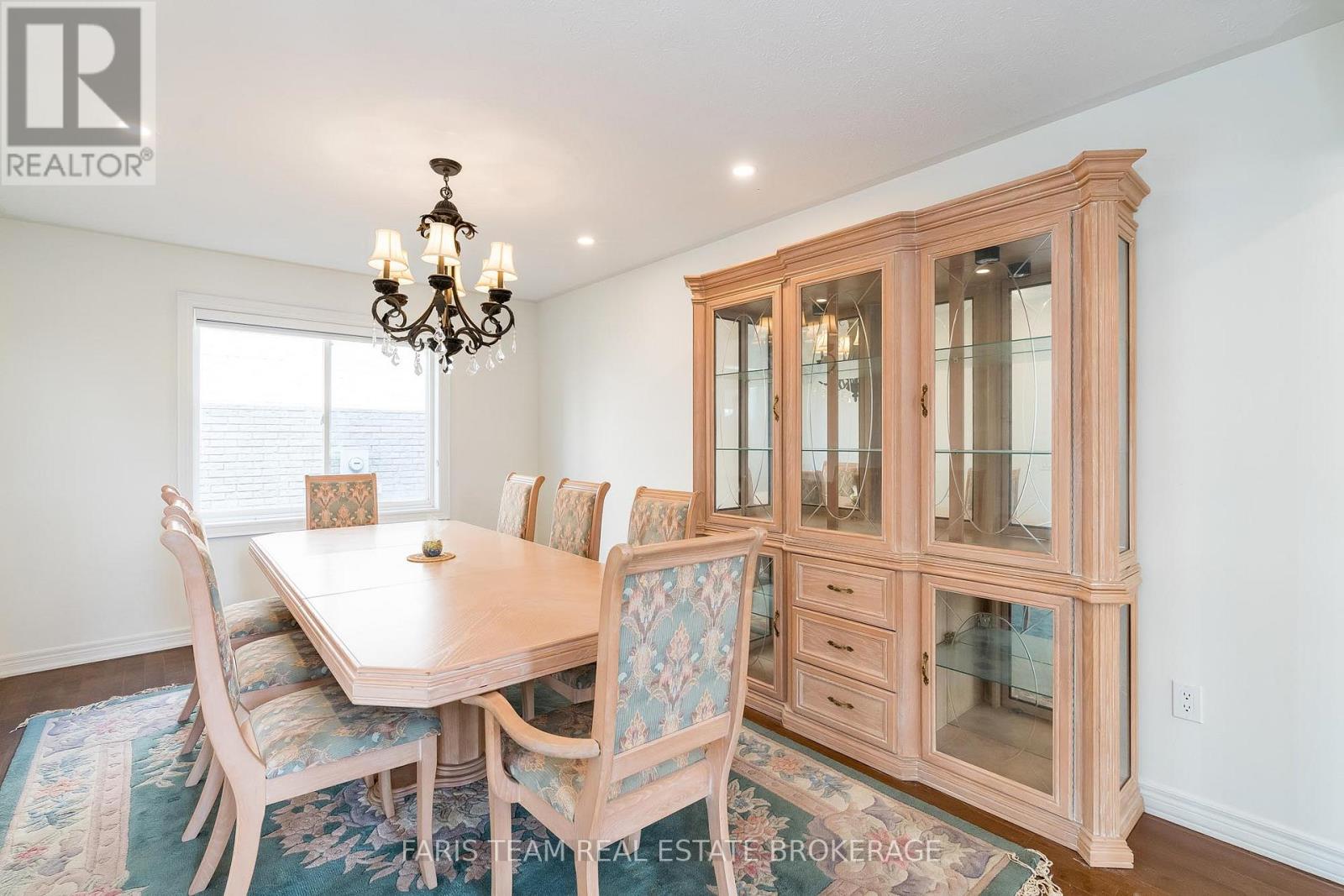 A dining room with a table set for six.