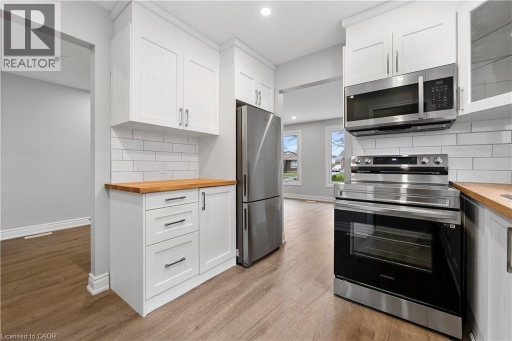A kitchen with white cabinets and stainless steel appliances.