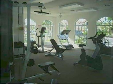 A gym with exercise equipment and windows.